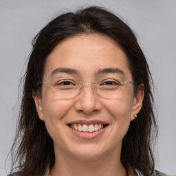 Joyful white adult female with medium  brown hair and brown eyes