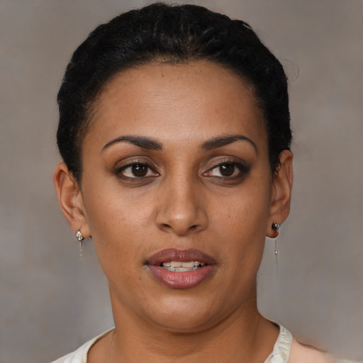 Joyful latino young-adult female with short  black hair and brown eyes
