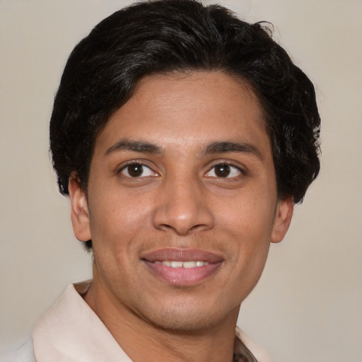 Joyful latino young-adult male with short  brown hair and brown eyes