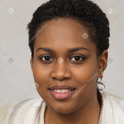 Joyful black young-adult female with short  brown hair and brown eyes