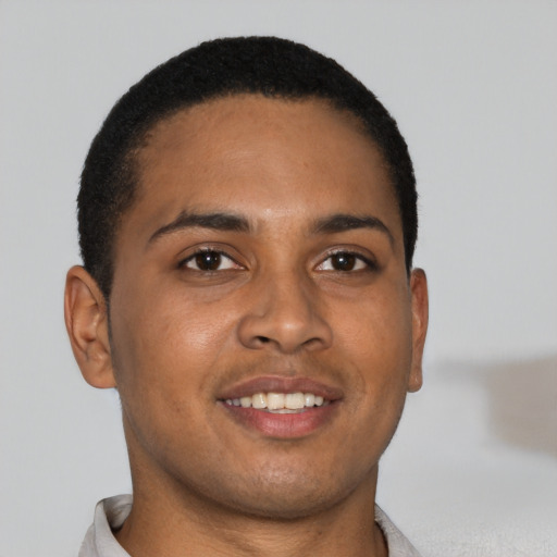 Joyful black young-adult male with short  brown hair and brown eyes
