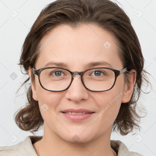 Joyful white young-adult female with medium  brown hair and blue eyes