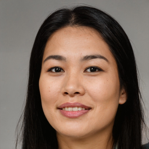 Joyful asian young-adult female with long  black hair and brown eyes