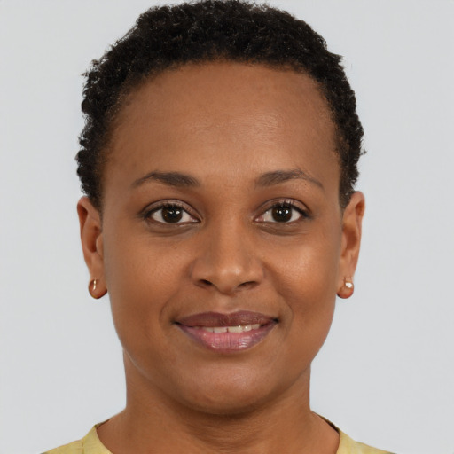 Joyful black young-adult female with short  brown hair and brown eyes