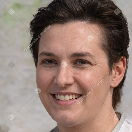 Joyful white adult female with short  brown hair and brown eyes