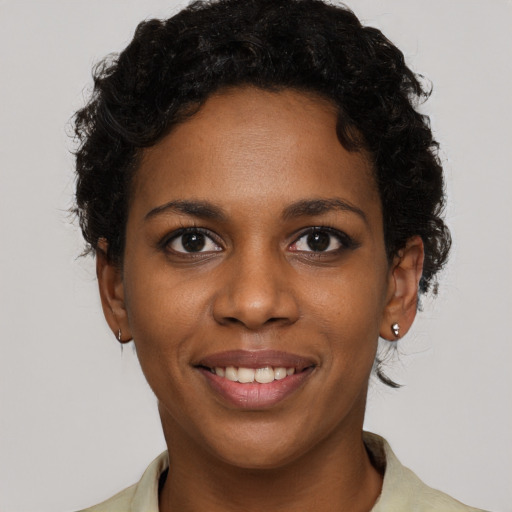 Joyful black young-adult female with short  brown hair and brown eyes