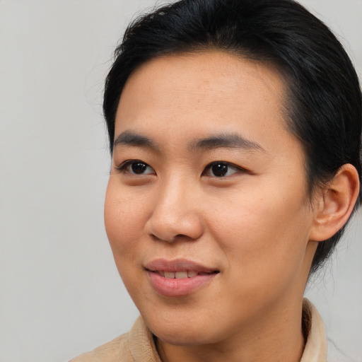 Joyful asian young-adult male with medium  brown hair and brown eyes