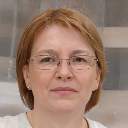 Joyful white adult female with medium  brown hair and blue eyes