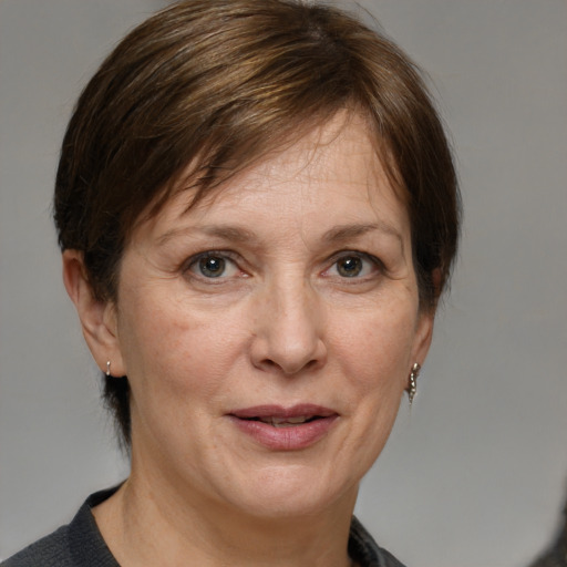 Joyful white adult female with medium  brown hair and grey eyes