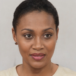 Joyful black young-adult female with short  brown hair and brown eyes