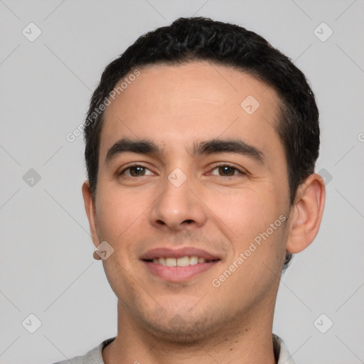 Joyful white young-adult male with short  black hair and brown eyes