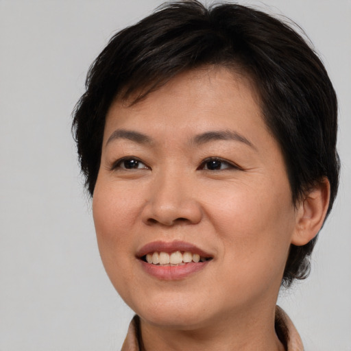 Joyful asian young-adult female with short  brown hair and brown eyes