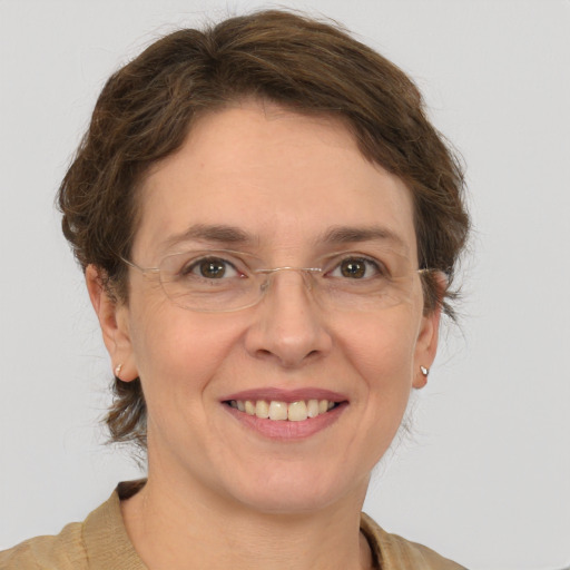 Joyful white adult female with medium  brown hair and grey eyes