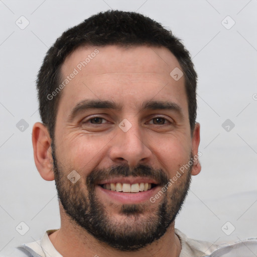 Joyful white young-adult male with short  black hair and brown eyes