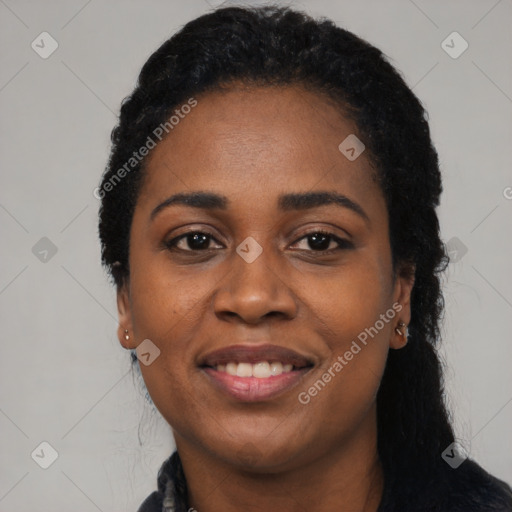 Joyful black young-adult female with long  black hair and brown eyes