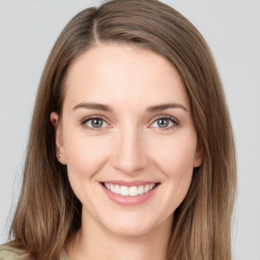 Joyful white young-adult female with long  brown hair and grey eyes