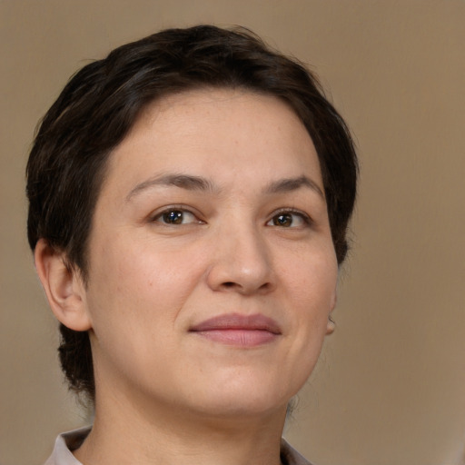 Joyful white adult female with medium  brown hair and brown eyes