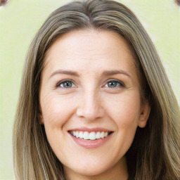 Joyful white young-adult female with long  brown hair and green eyes