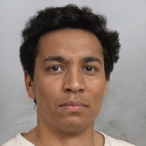 Neutral latino adult male with short  black hair and brown eyes