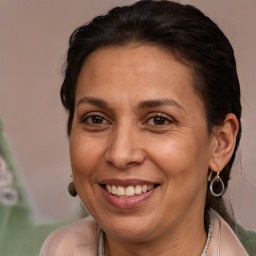 Joyful white adult female with long  brown hair and brown eyes