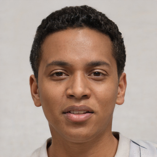Joyful black young-adult male with short  black hair and brown eyes