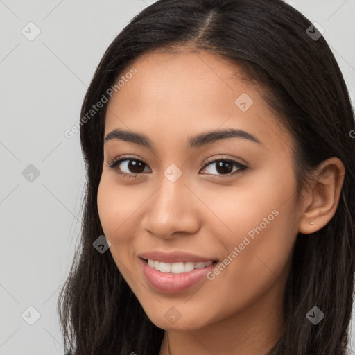 Joyful latino young-adult female with long  brown hair and brown eyes