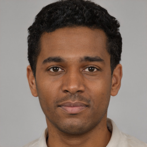 Neutral black young-adult male with short  black hair and brown eyes