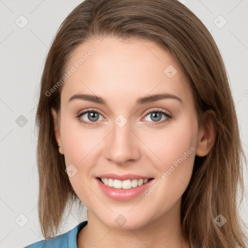 Joyful white young-adult female with long  brown hair and blue eyes