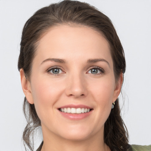 Joyful white young-adult female with long  brown hair and grey eyes