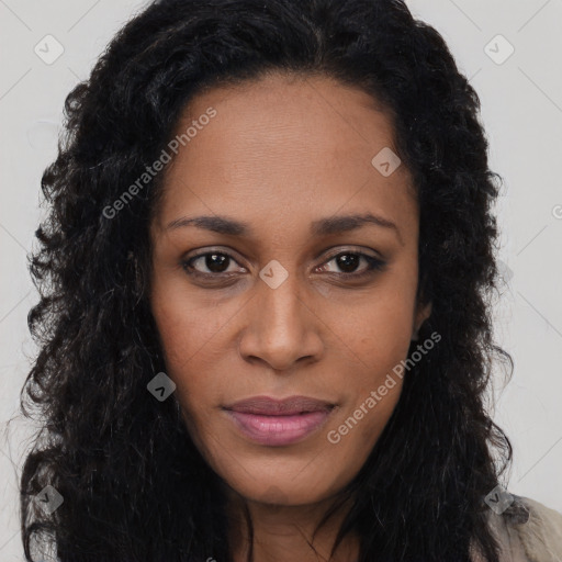 Joyful black young-adult female with long  black hair and brown eyes