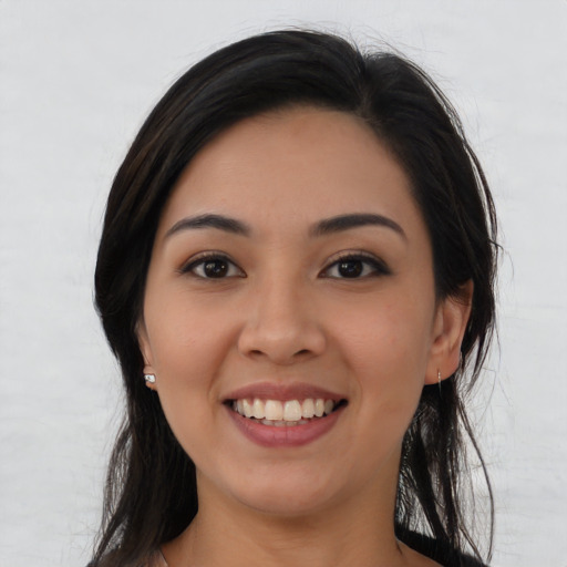 Joyful asian young-adult female with long  brown hair and brown eyes