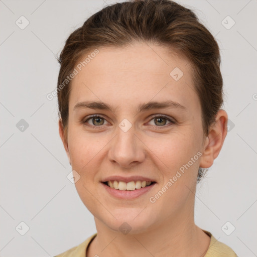 Joyful white young-adult female with short  brown hair and grey eyes