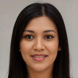 Joyful latino young-adult female with long  brown hair and brown eyes