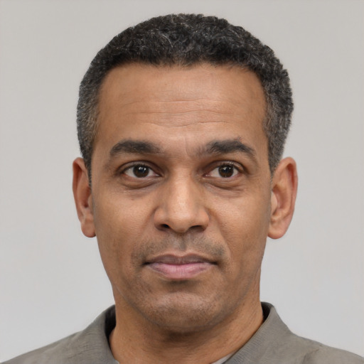 Neutral latino adult male with short  black hair and brown eyes