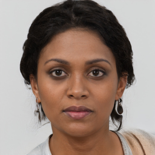 Neutral black young-adult female with medium  brown hair and brown eyes