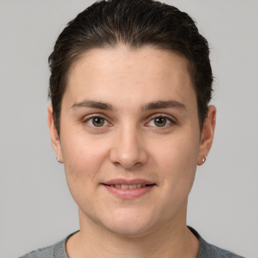 Joyful white young-adult female with short  brown hair and brown eyes