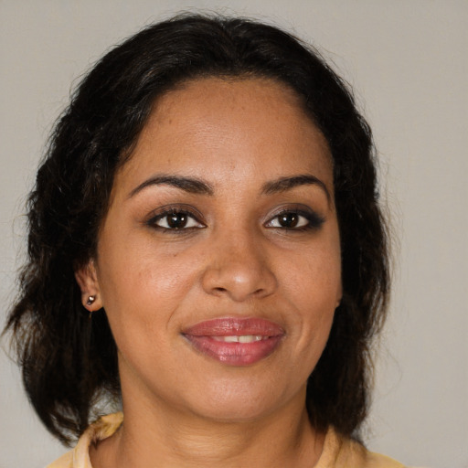 Joyful black young-adult female with medium  brown hair and brown eyes