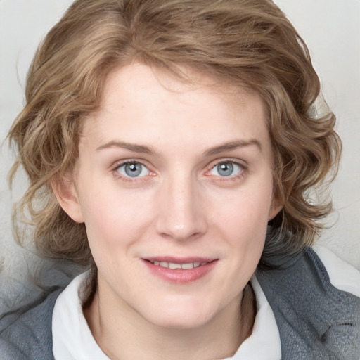 Joyful white young-adult female with medium  brown hair and blue eyes