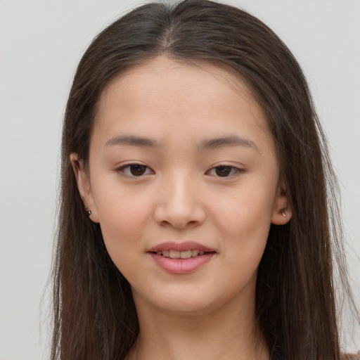 Joyful asian young-adult female with long  brown hair and brown eyes