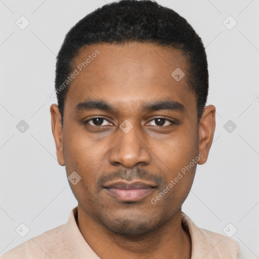 Joyful black young-adult male with short  black hair and brown eyes