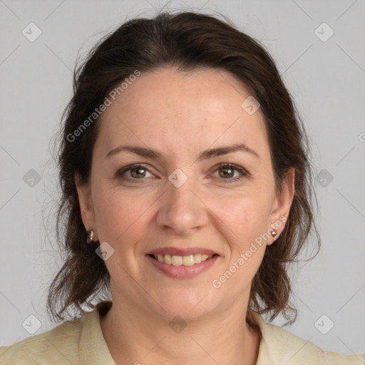 Joyful white adult female with medium  brown hair and grey eyes