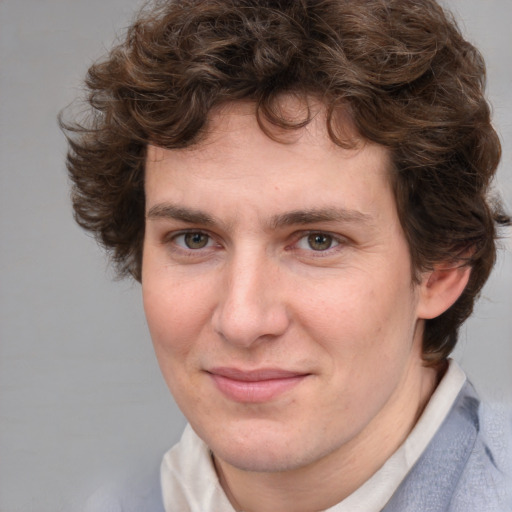 Joyful white adult male with medium  brown hair and brown eyes