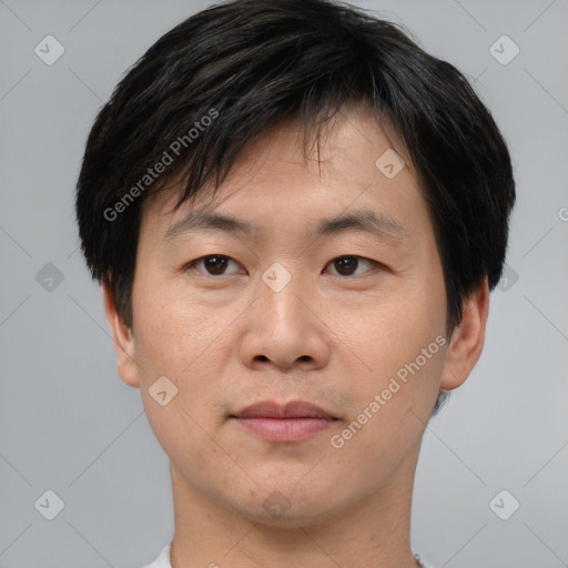 Joyful asian young-adult male with short  brown hair and brown eyes