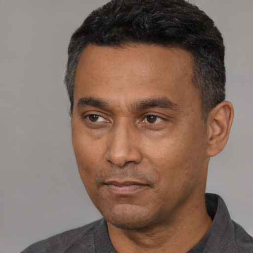 Neutral latino adult male with short  black hair and brown eyes