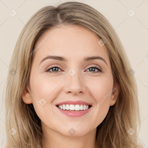 Joyful white young-adult female with long  brown hair and brown eyes