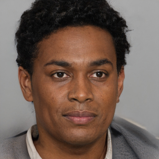 Neutral black young-adult male with short  black hair and brown eyes
