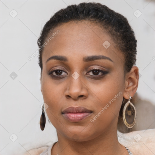 Joyful black young-adult female with long  brown hair and brown eyes