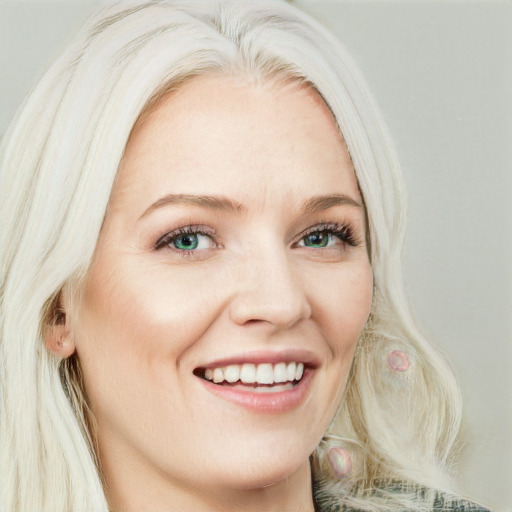 Joyful white young-adult female with long  blond hair and blue eyes