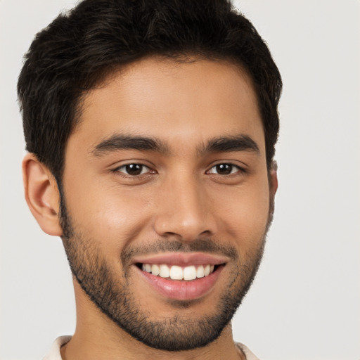 Joyful white young-adult male with short  brown hair and brown eyes