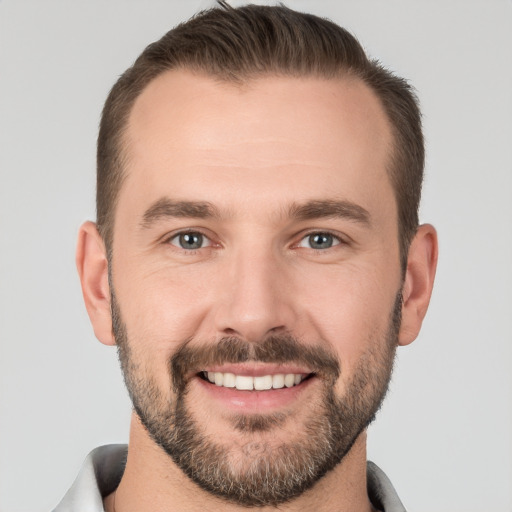 Joyful white young-adult male with short  brown hair and brown eyes